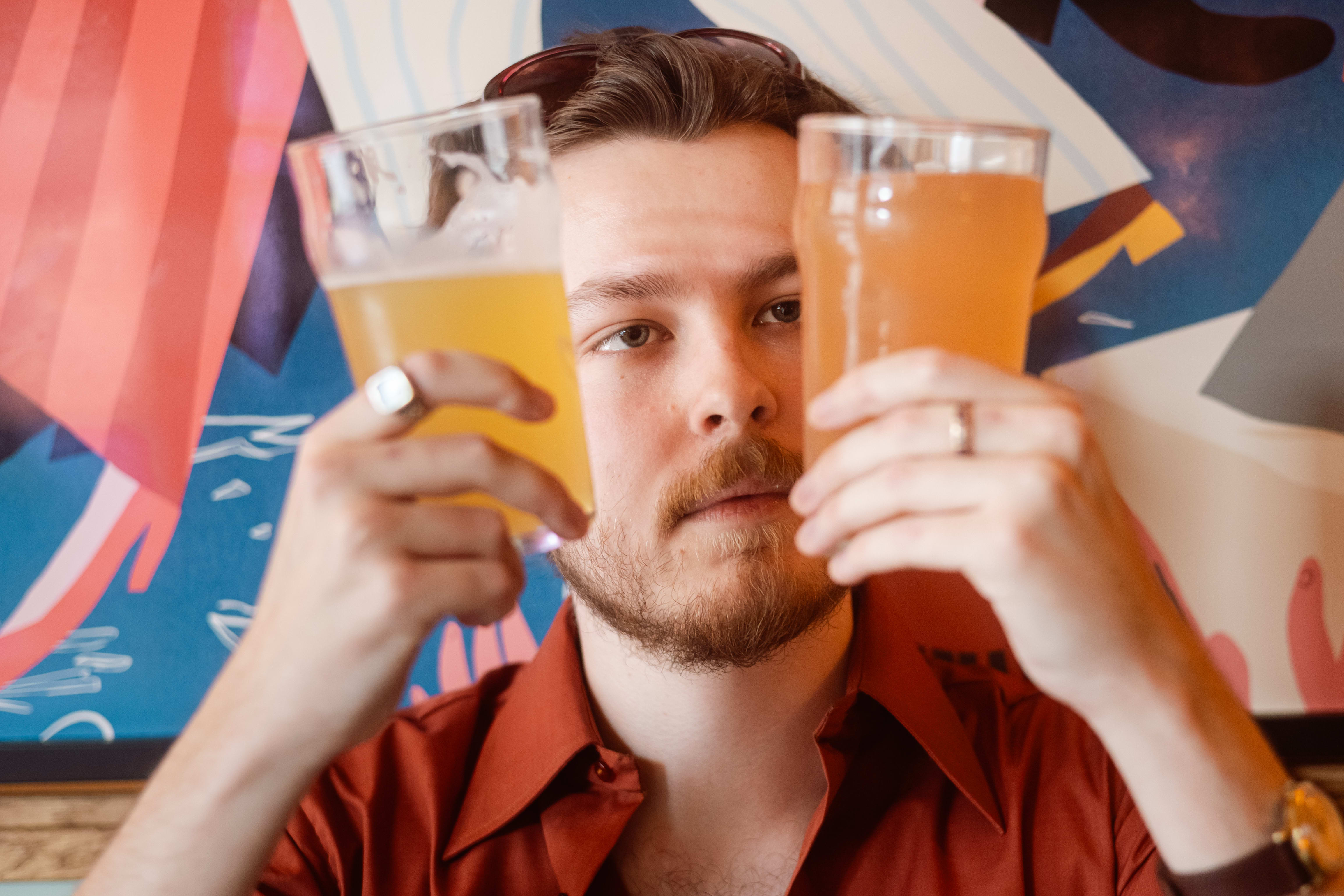 Åsmund Halleraker holder opp en shandy og en radler med grapefrukt-smak. 