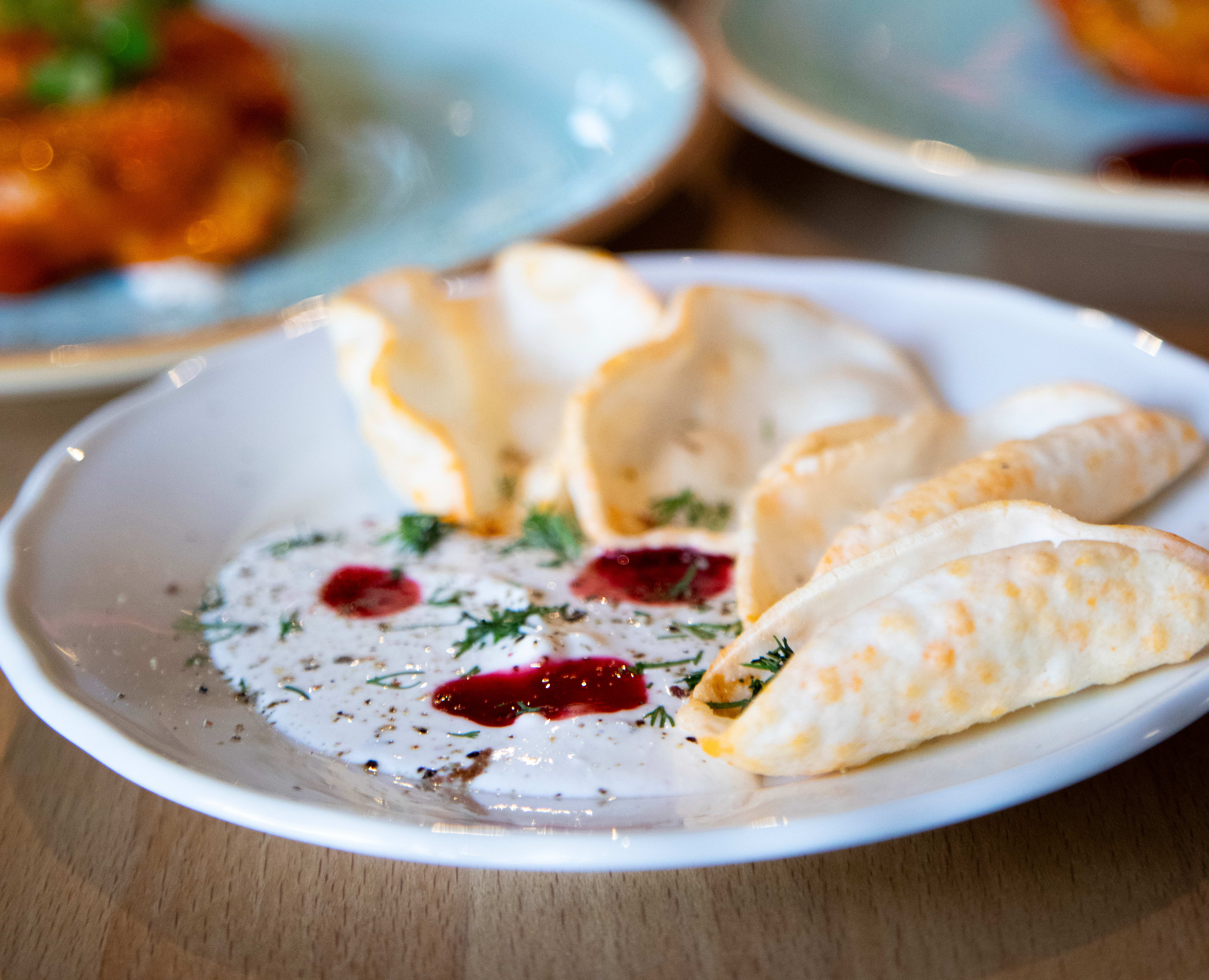 En liten snacks står raskt på bordet. Chips med hummus. 