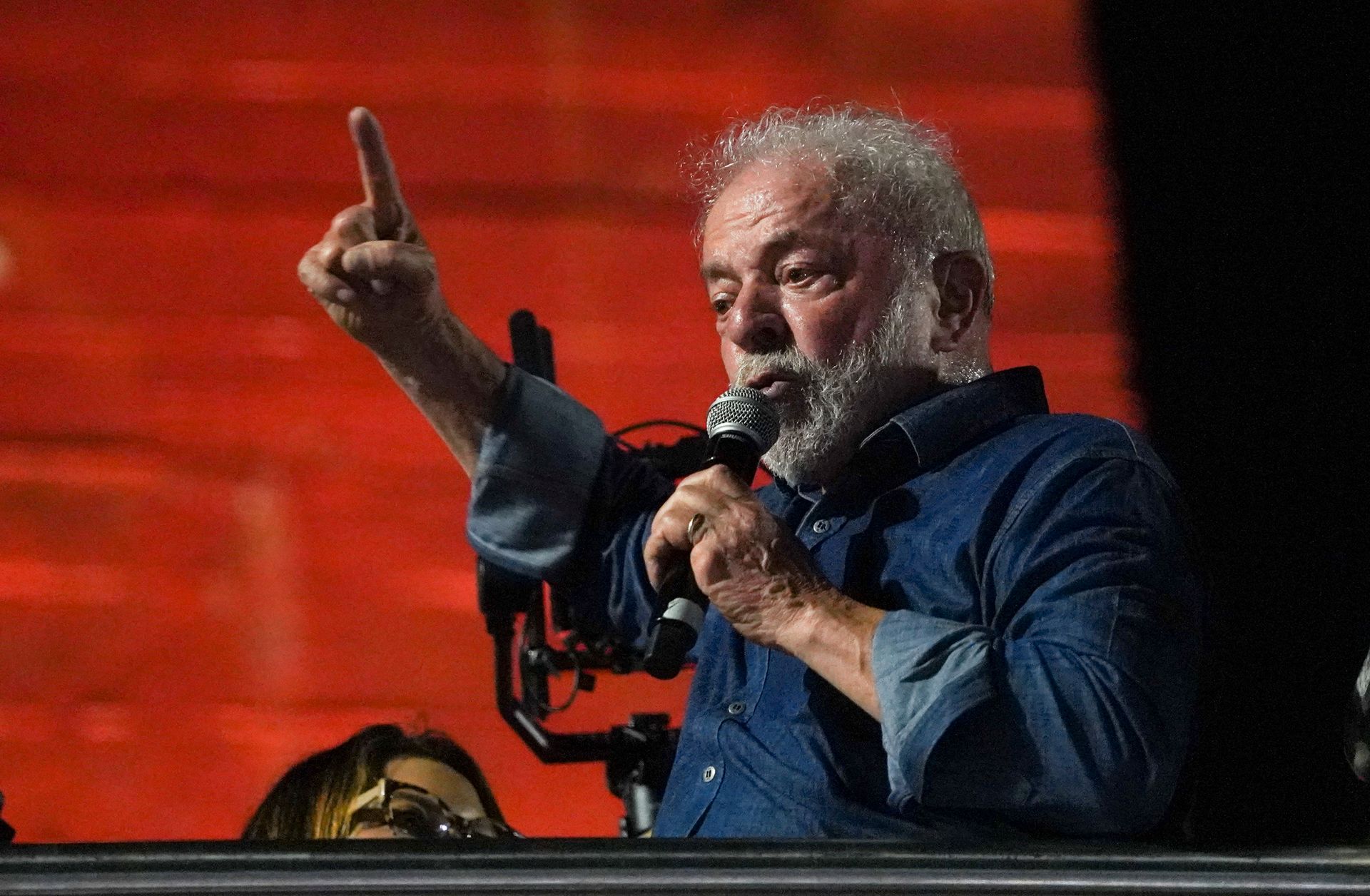 Lula holder en mikrofon og taler