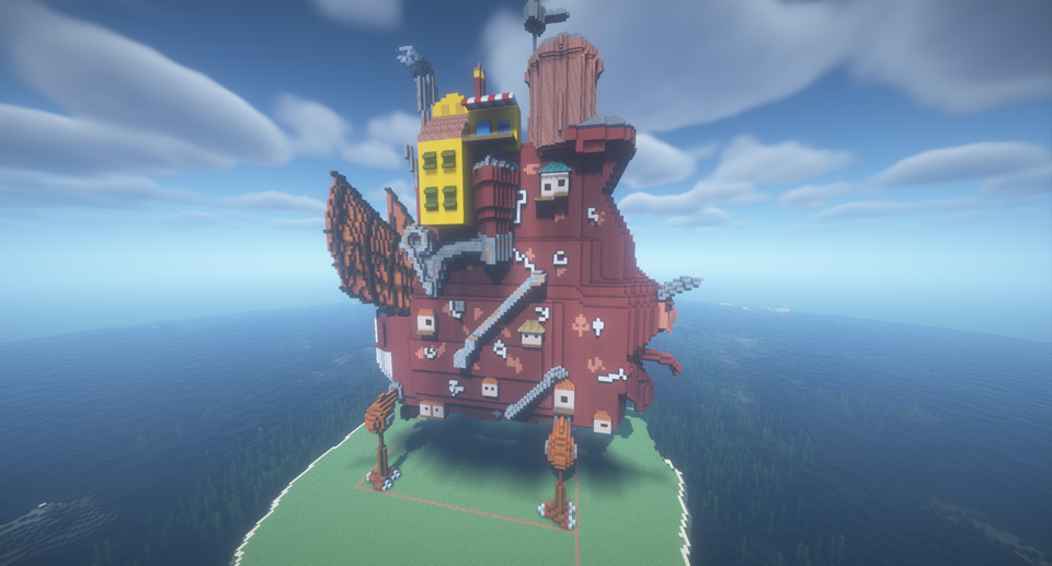 Bilde fra Minecraft av et stort rødt fugleaktig bygg på en øy. 