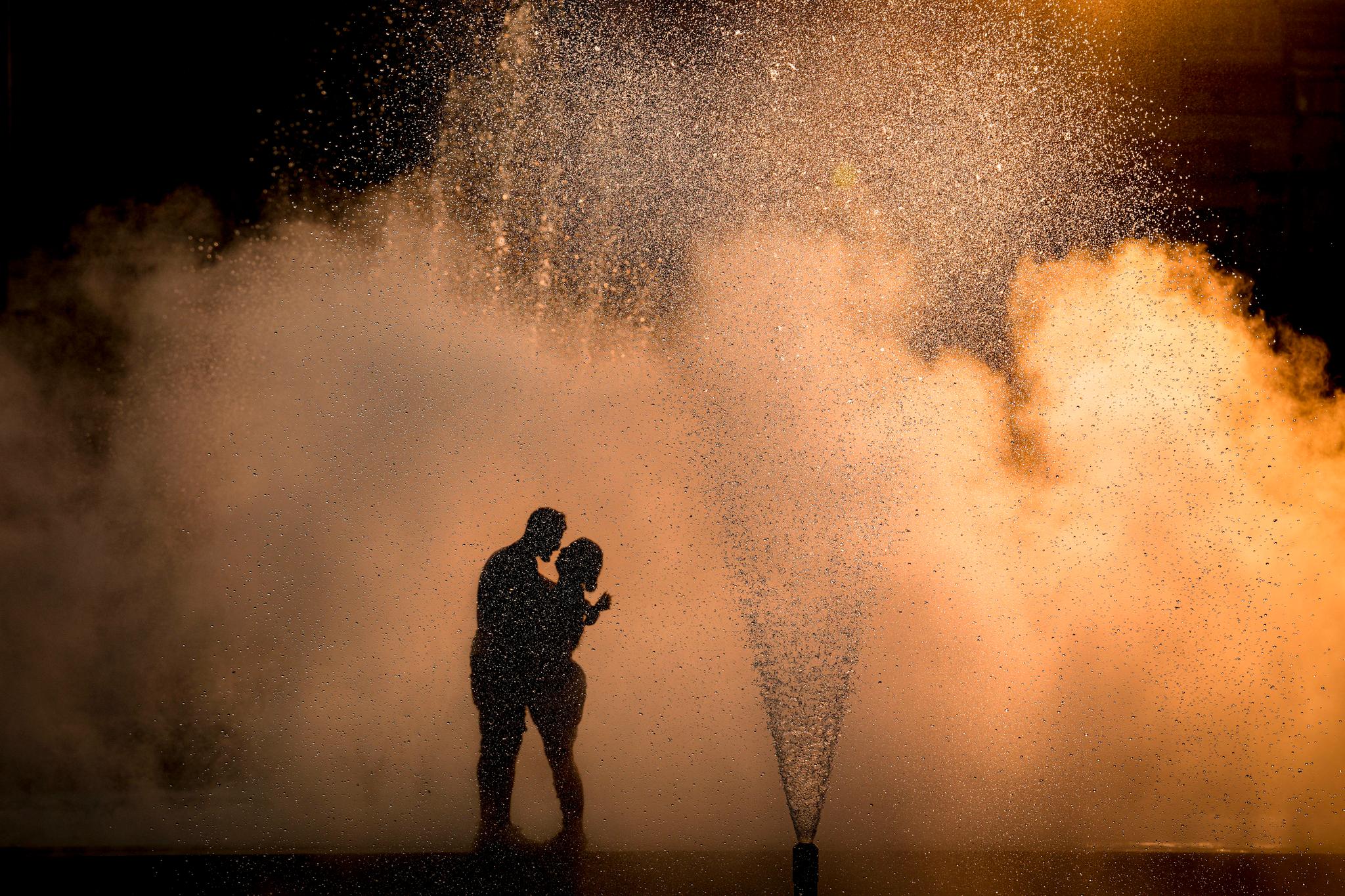 Et par gir hverandre en klem i en fontene i Bucuresti. Nok en hetebølge er på vei. 