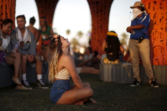 A woman sits in front of  the "Pulp Pavilion" art installation by Ball-Nogues Studio at the Coachella Valley Music and Arts Festival in Indio, California April 12, 2015. REUTERS/Lucy Nicholson