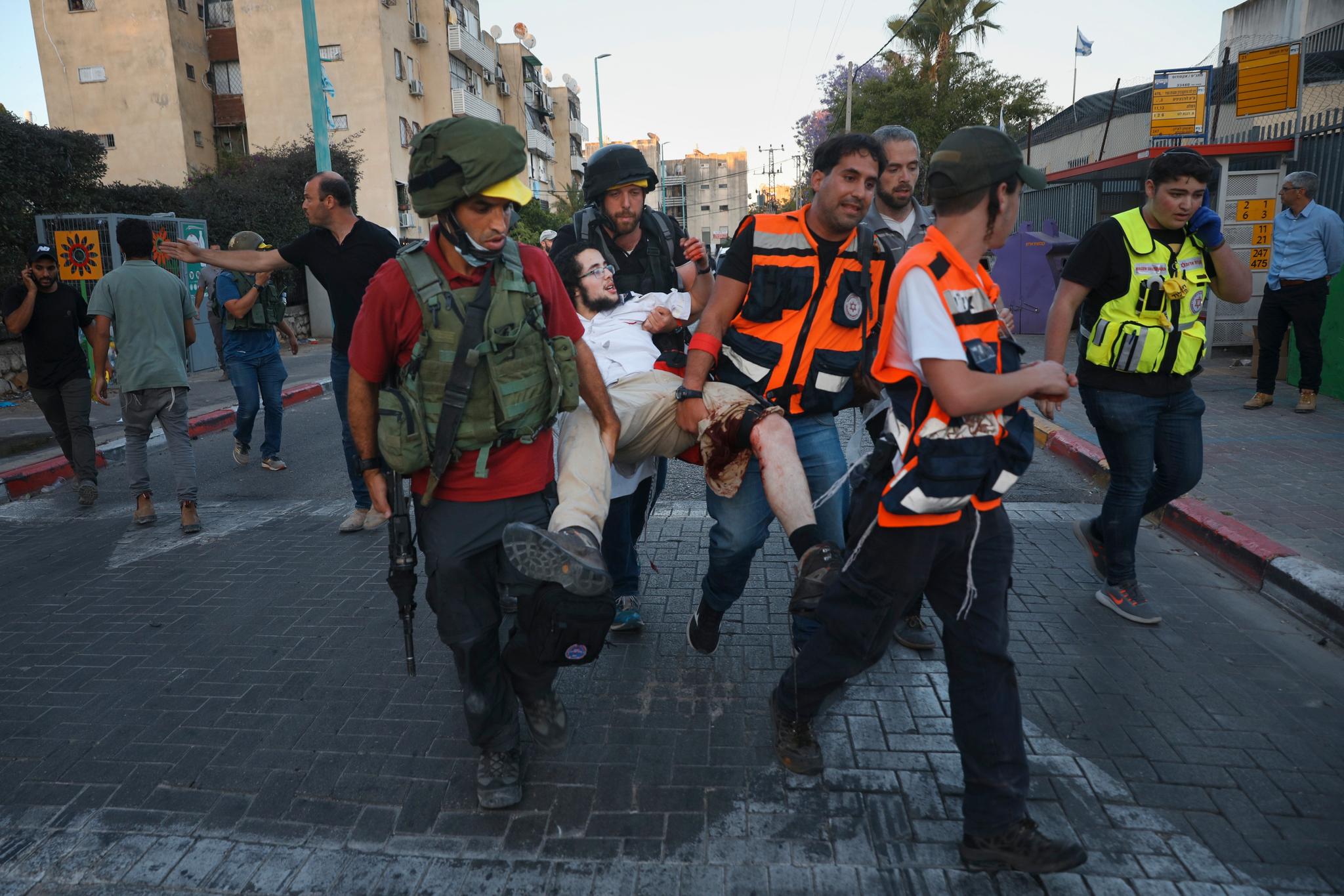 En jødisk mann får hjelp etter at han ble skutt under sammenstøtene.