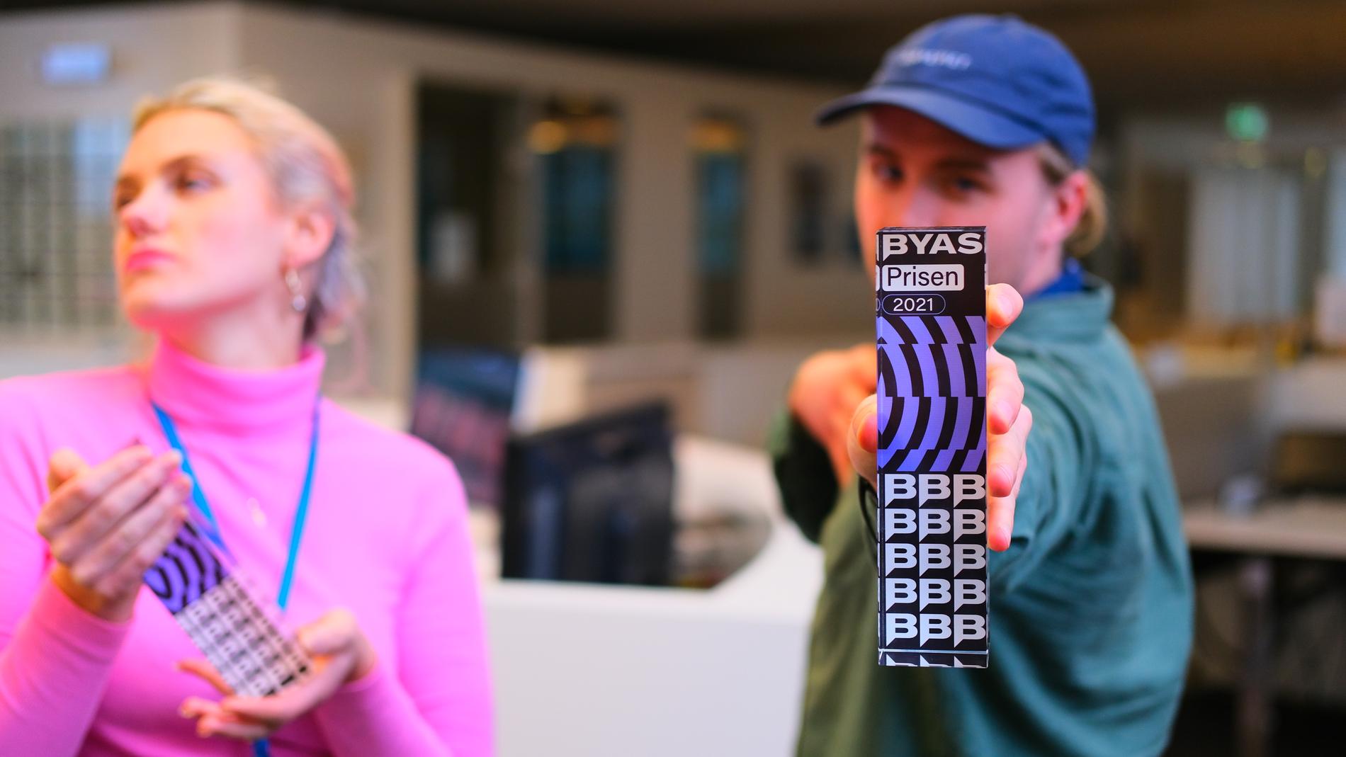 Stella Marie Brevik og Elias Håvarstein viser stolt frem en av de gjeveste #byasbeste-prisene: Byas-prisen.