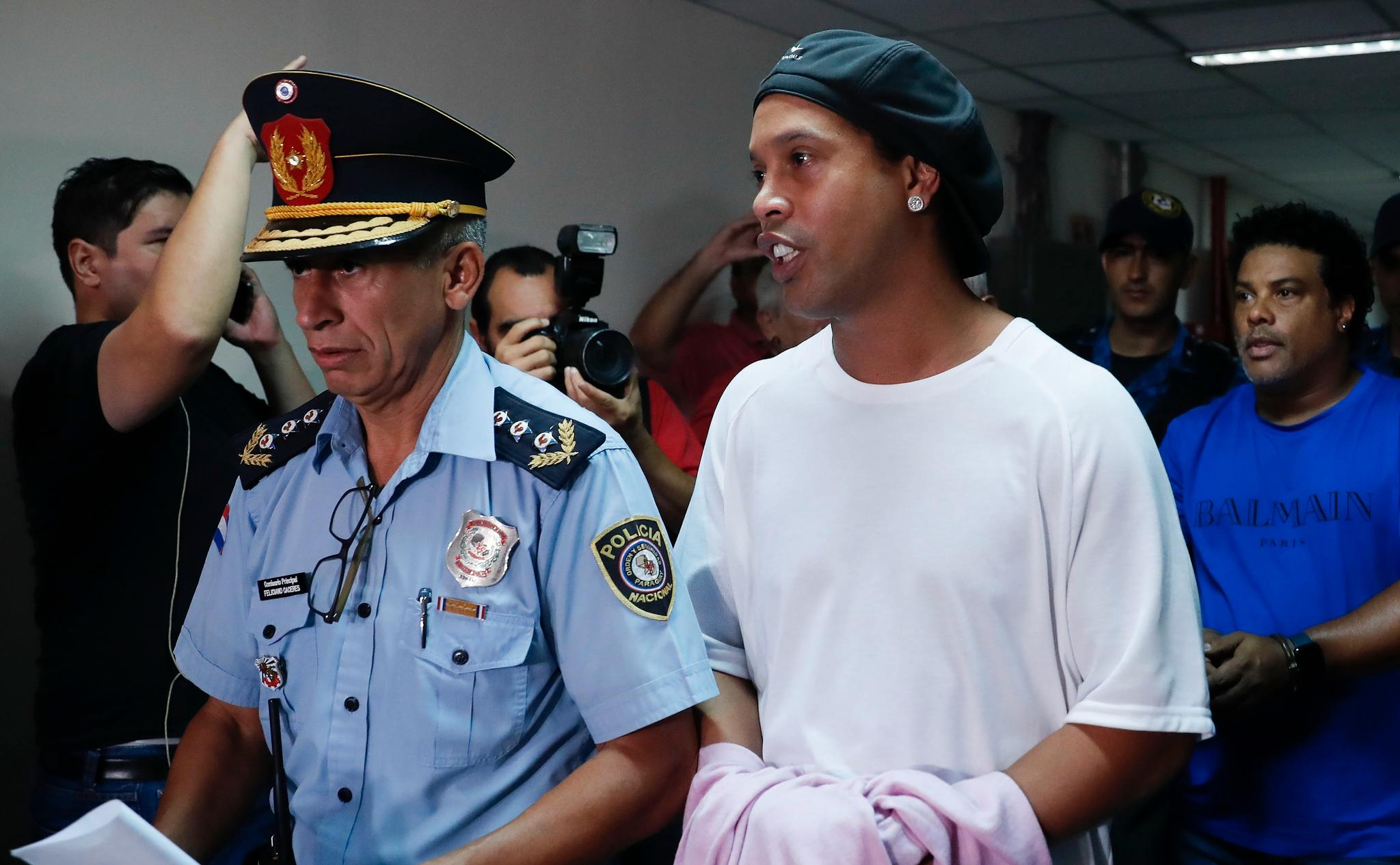 Ronaldinho på vei ut av rettssalen i Paraguay forrige måned.