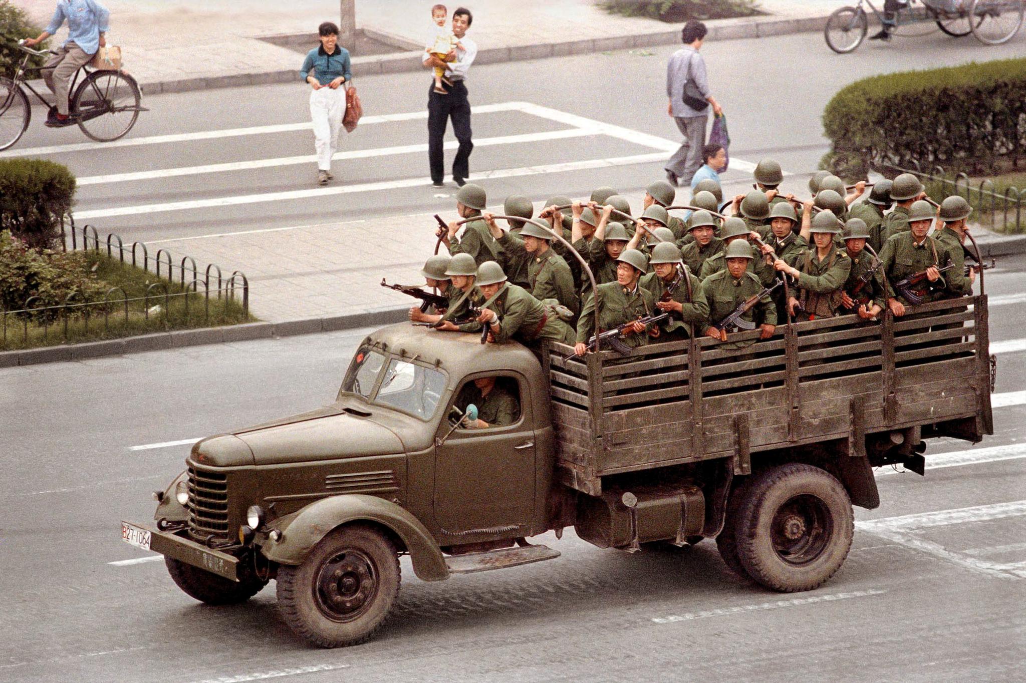 4. juni 1989: En lastebil med soldater fra Folkets frigjøringshær patruljerer Chang'an dagen etter at flere hundre, muligens tusener, ble drept i gatene rundt Den himmelske fredsplass. 